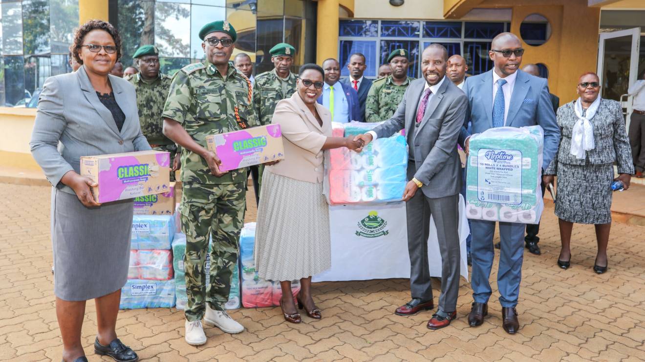 Salome Muhia Beacco handing items to David Githada at the Mwea GK prisons. PHOTO/COURTESY